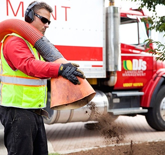 DJ's Landscape Management employee providing mulch installation services