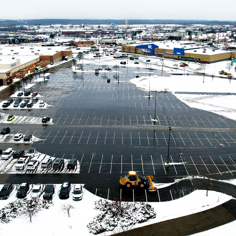 aerial shot of a retail center parking lot showing DJ's commercial snow and ice management services