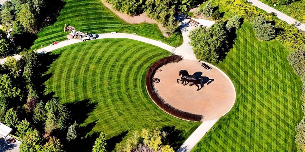 aerial shot of a commercial property landscape with freshly mowed grass and paved walkways