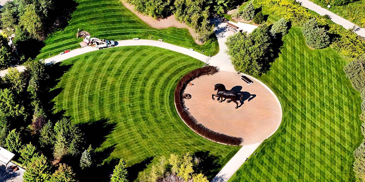 aerial shot of a commercial property landscape with freshly mowed grass and paved walkways