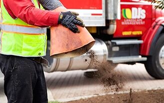DJ's Landscape Management employee spreading mulch