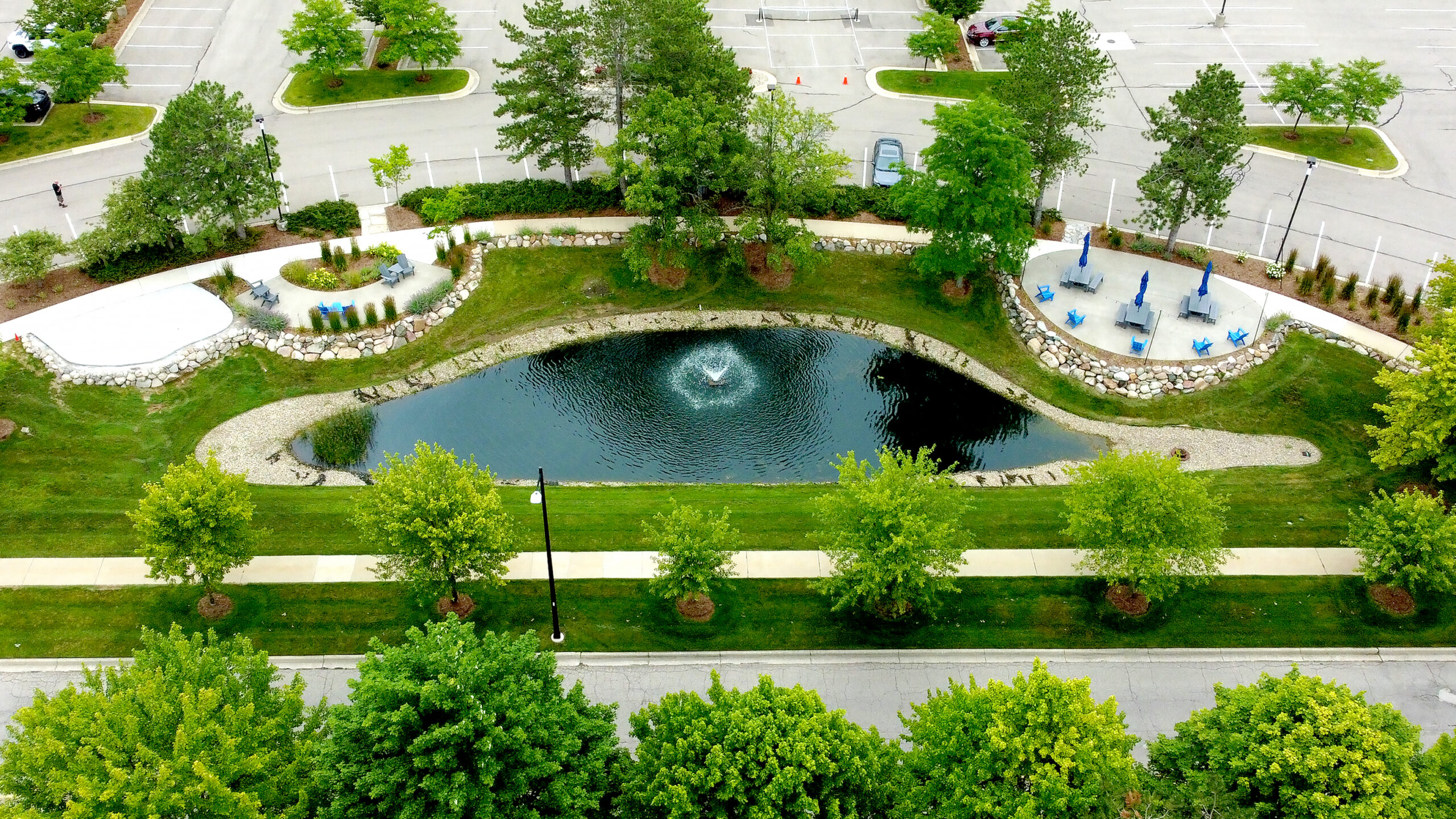 boulder wall bordering a pond at a landscape construction site